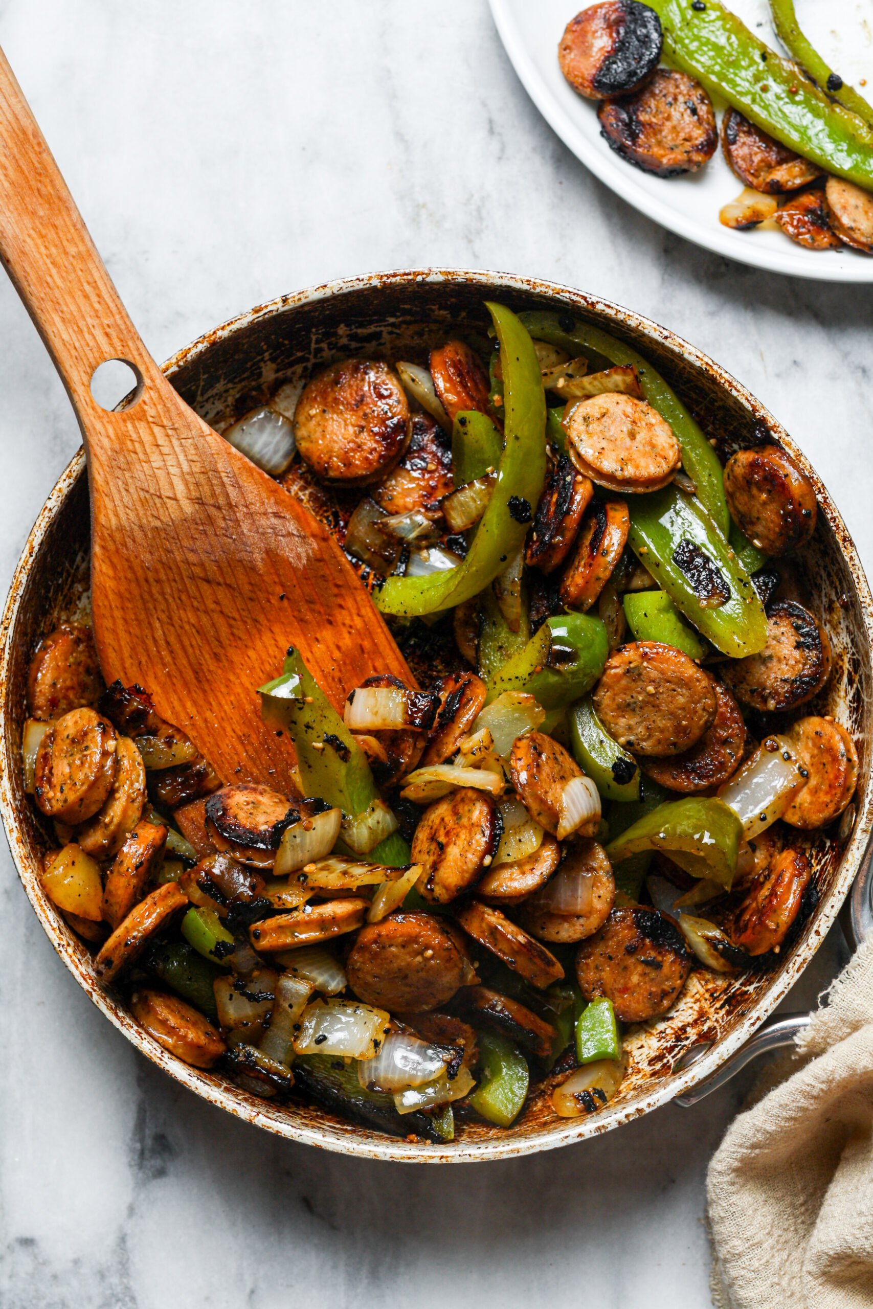 Pork, peppers, and onions in skillet.