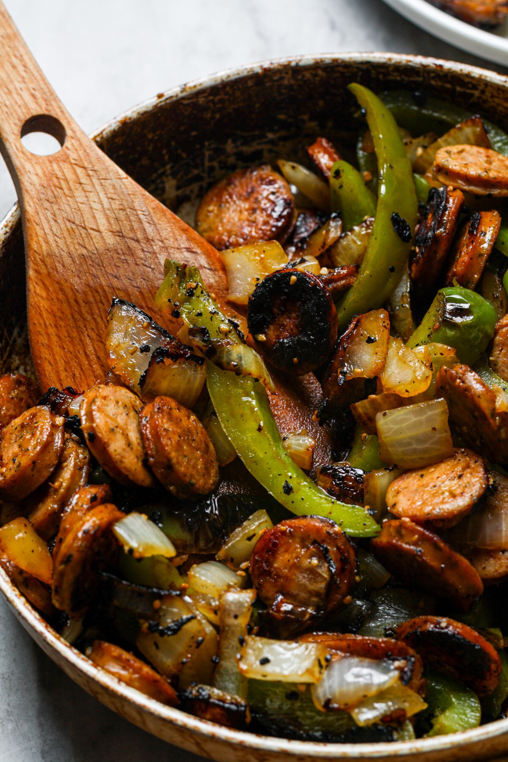Meat and veggies in skillet.